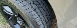 Close-up of Continental TerrainContact H/T tire on SUV, showing detailed tread design with stable center ribs for a smooth and quiet ride.